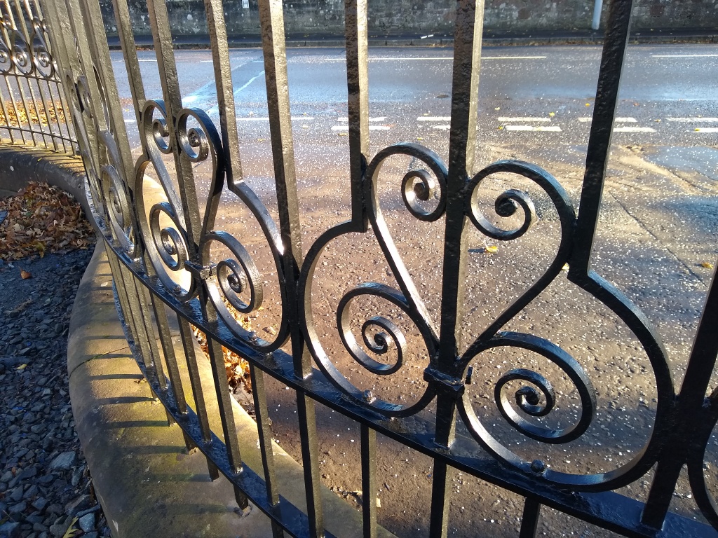 Close-up of lower section of restored railings showing detail of ironwork.
